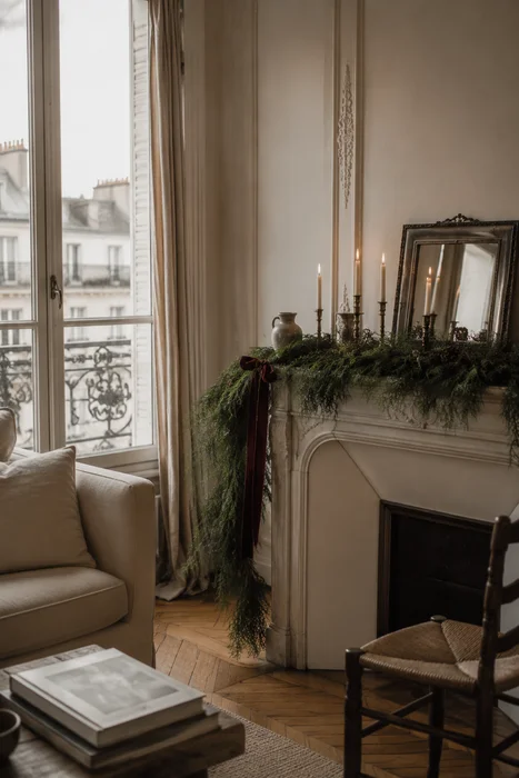 The Art of Styling Norfolk Pine Natural Touch Garland for Christmas 7 Long evergreen garland with taper candles and burgundy ribbon on Parisian fireplace