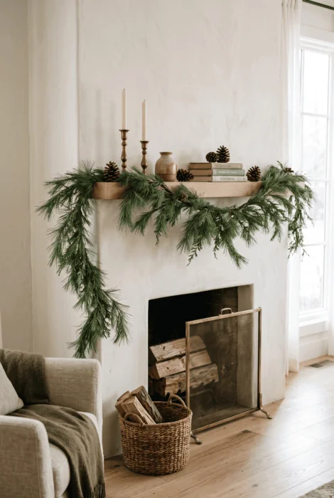 The Art of Styling Norfolk Pine Natural Touch Garland for Christmas 4 Minimal evergreen garland with pinecones, books, pottery, and brass candlesticks